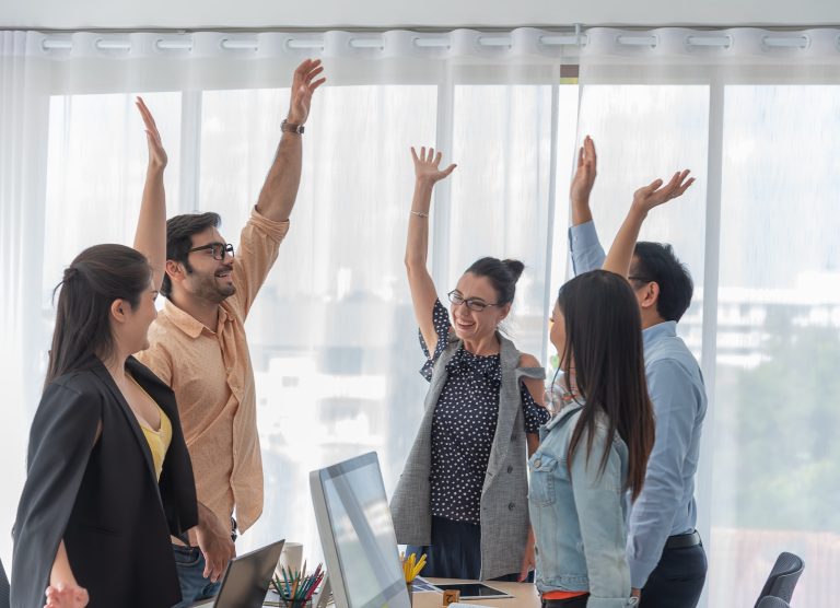 Happy business people celebrating success at office