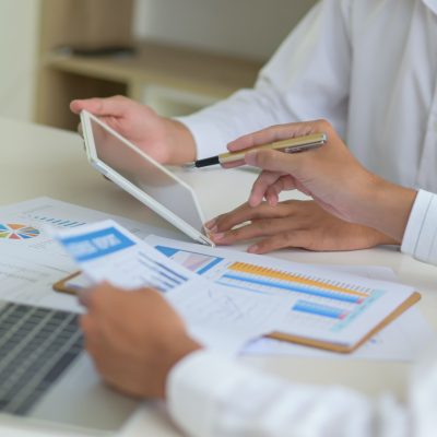 Executives with tablet are evaluating the situation of company to resolve impact of virus outbreak.